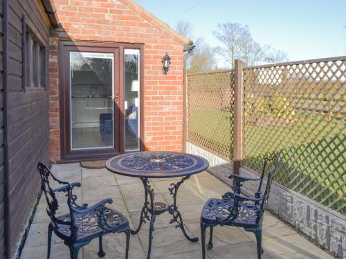 a table and two chairs on a patio at Willow Tree Farm in Sutton on Sea