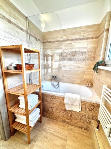a bathroom with a bath tub and a sink at Samaria Central Apartment in Šamorín
