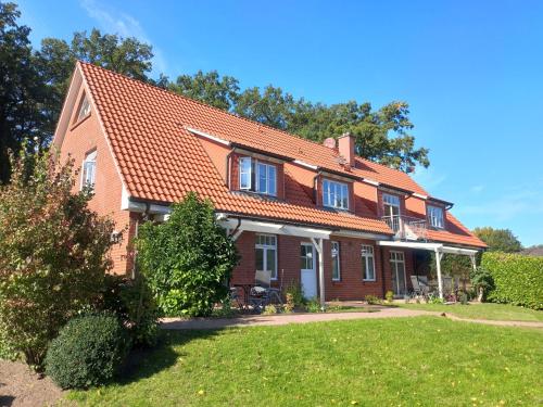 a brick house with an orange roof at Haus-Auetal in Bliedersdorf
