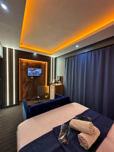 a hotel room with two beds and a couch at tuzla first house in Tuzla