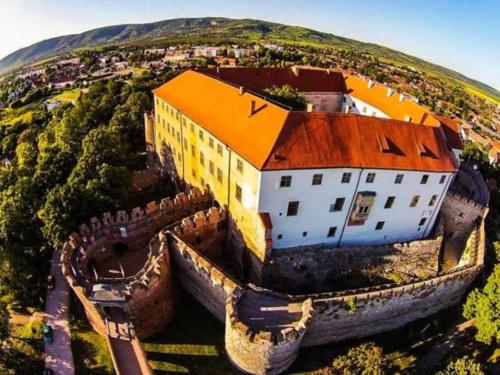 an aerial view of a large building on a hill at Oázis Apartman in Harkány