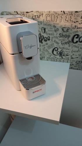 a white sewing machine sitting on top of a counter at Nido Flegreo in Pozzuoli