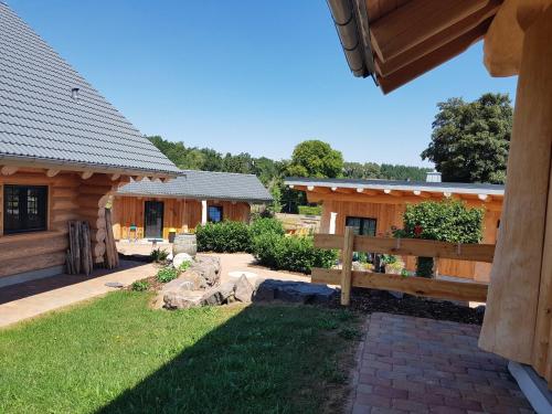 a couple of buildings with a yard and a fence at Steirer-Hof in Vöhl