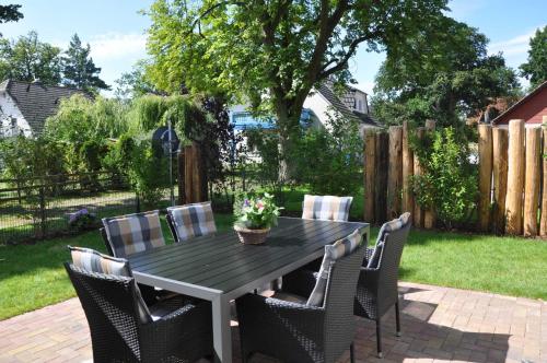 a table and chairs in a backyard at Haus "Fock" in Prerow