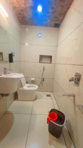 a bathroom with a toilet and a sink at gulmarg peak view resort in Gulmarg