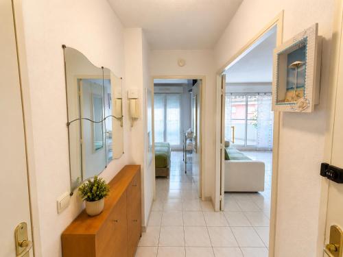 a hallway with a mirror and a living room at La Terrasse Bleue-Parking couvert-2 min plage-Juan Les Pins in Antibes