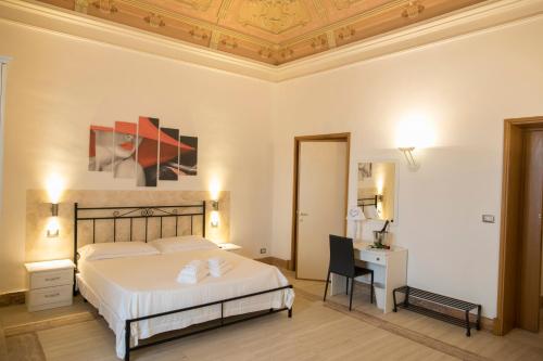 a hotel room with a bed and a desk at B&B Liberty 900 in Catania