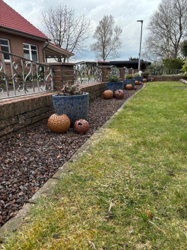 a yard with pumpkins sitting on the grass at Ferienwohnung Wellenkamp in Itzehoe