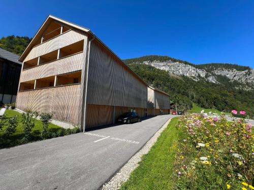 a building with a car parked in front of it at Apartment Kanisfluh in Mellau