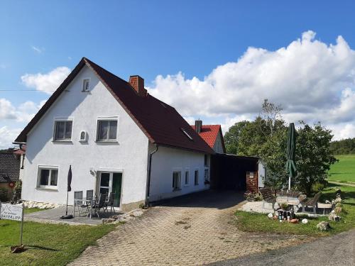 a white house with a black roof at Ferienhaus Bayerlipp in Scheßlitz