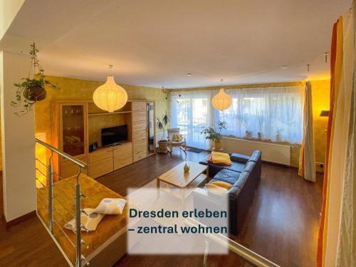 a living room with a couch and a table at Dresden, Ferienhaus Strietzel in Dresden