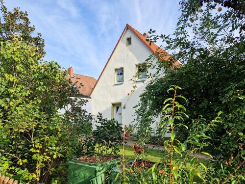 a white house with a red roof at Dresden, Ferienhaus Strietzel in Dresden