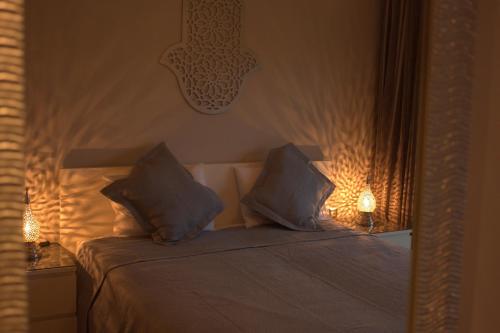 a bedroom with a bed with two pillows on it at Prestigia Golf City Apartment in Marrakesh