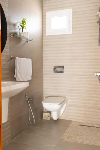 a bathroom with a toilet and a sink at Villa Zain in Houmt Souk