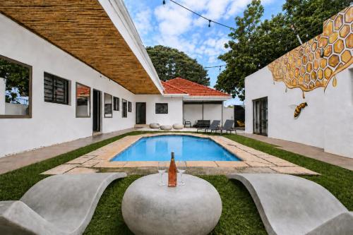 a swimming pool in the backyard of a house at Hunni Hotel Melrose Edge in Johannesburg