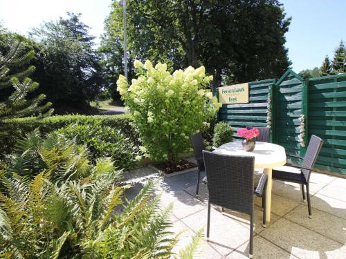 a patio with a table and chairs in a garden at Ferienhaus Smerzinski in Bergen auf Rügen