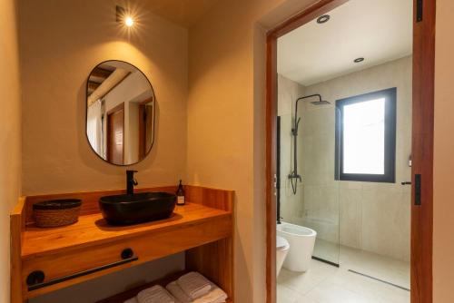 a bathroom with a sink and a mirror and a shower at Alma de Purmamarca in Purmamarca