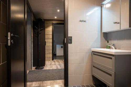 a bathroom with a sink and a mirror at Sea Haven Villa in Trutberget