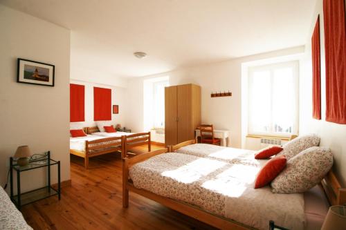 a bedroom with a bed and a living room at Le Clos Auvergnat in Tauves