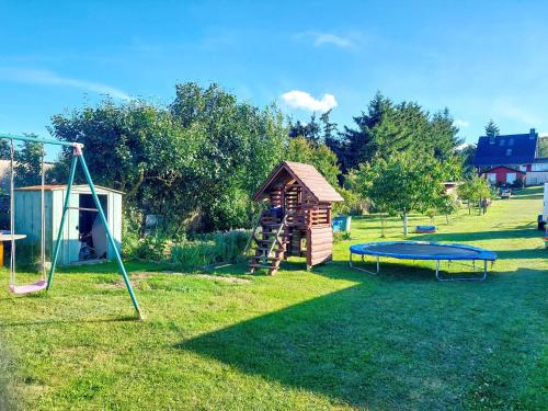 a playground with a trampoline and a play structure at Ferienwohnung Haus Möwe in Freest