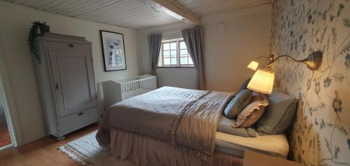 a bedroom with a bed with a lamp on it at Family-friendly house near Söderåsen Natinal Park in Slättåkra