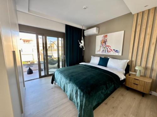 a bedroom with a bed with a green blanket at Alimos Escape 3 in Athens