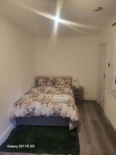 a bedroom with a bed in a white room at Perfectspot in Tilbury