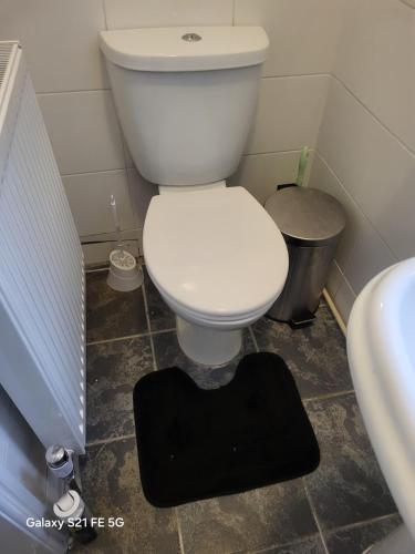 a bathroom with a white toilet and a sink at Perfectspot in Tilbury