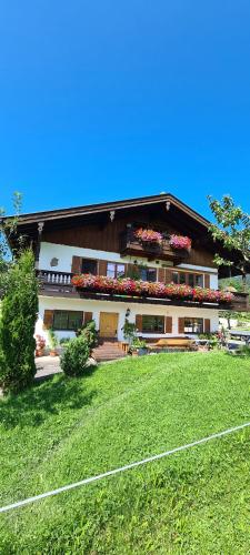 a house with flowers on the side of it at Maria Schnitzenbaumer in Fischbachau