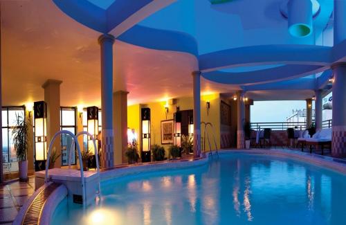 a large swimming pool in the middle of a building at Asia Hotel Hue in Hue