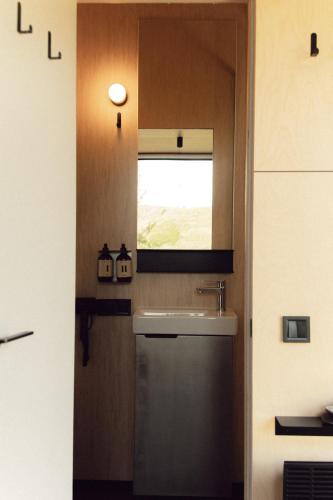 a bathroom with a sink and a window at Dvoye in Vodniki