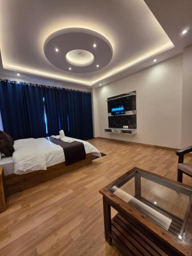 a bedroom with a bed and a tv on the ceiling at Rahini sunset villa in Shimla
