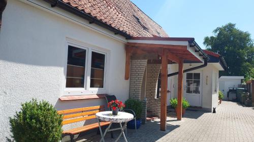a house with a bench and a table in front of it at Ferienwohnung Hilde Schneider in Kappeln