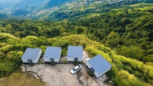 an aerial view of a house with blue roofs and a car at The Forest View ภูทับเบิก in Ban Maeo Thap Boek