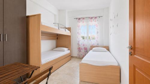 a small bedroom with a bunk bed and a desk at PROPERSTAY 112 - Maison Calme Polychrono in Polychrono