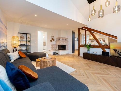 a living room with a couch and a fireplace at Villa Brunnenstraße, App 3 in Heringsdorf