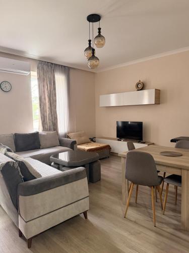 a living room with a couch and a table at Amazing flat in the best location in Tsqaltubo