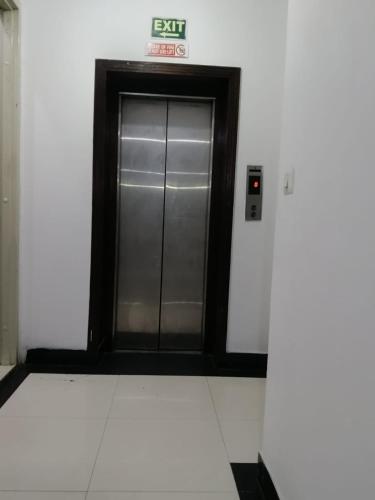 a elevator in a building with a glass door at Hotel Siam International Karol Bagh New Delhi in New Delhi