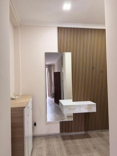 a bathroom with a sink and a mirror at Amazing flat in the best location in Tsqaltubo