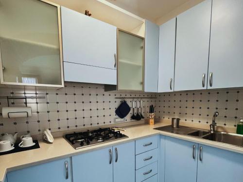 a kitchen with white cabinets and a sink at Casa Tasca in Ravello