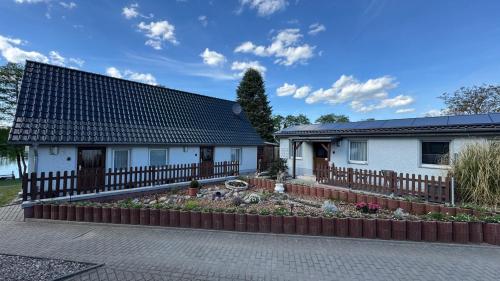 a house with a garden in front of it at FEWO Am Haussee Feldberger Seenlandschaft in Feldberg