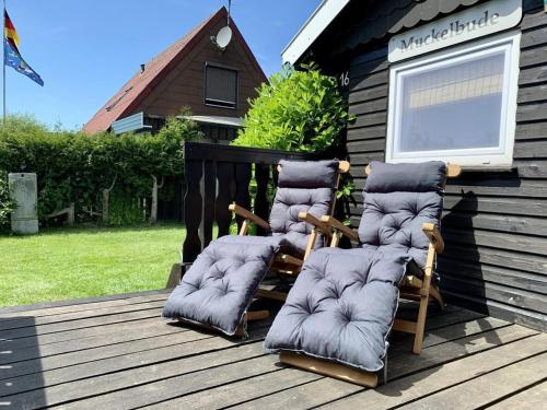 a group of chairs sitting on a wooden deck at Ferienhaus Muckelbude in Bedekaspel
