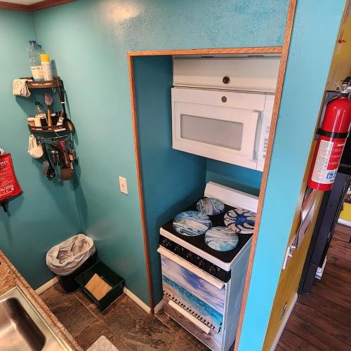 a small refrigerator with its door open in a room at Snugnuff in South Burlington