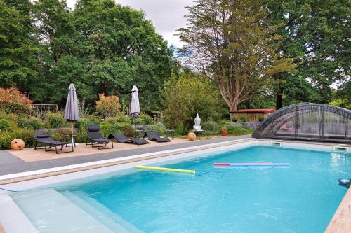 a swimming pool with paddles in a yard at Gite Douceur de vivre in Saint-Avaugourd-des-Landes