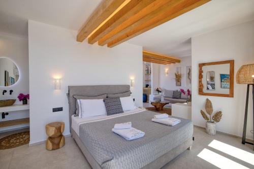 a bedroom with a bed with two towels on it at Ionic Suites in Super Paradise Beach