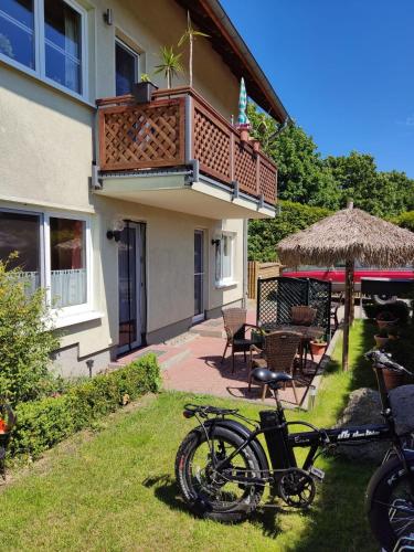 a bike parked in the grass in front of a house at Brandt Ferienwohnungen Jägersberg in Ahlbeck