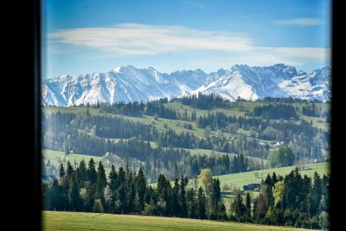 a view of a snowy mountain range from a window at Maruszyna Resort & SPA in Zakopane