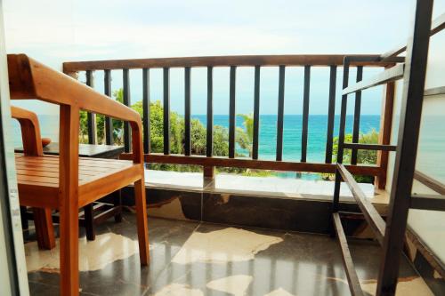 a balcony with a bench and a view of the ocean at Cozy Cocos Midigama in Ahangama
