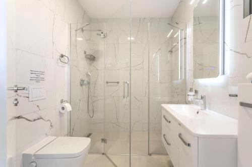 a bathroom with a shower and a toilet and a sink at Apartments Luna in Malinska