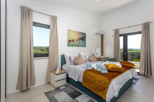 a bedroom with a bed and a large window at Apartments Luna in Malinska